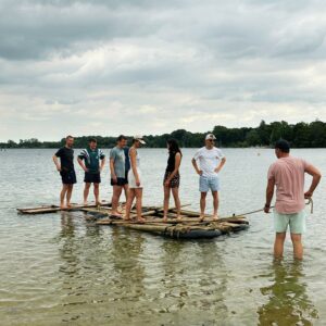 Gruppe steht auf dem Floß im See